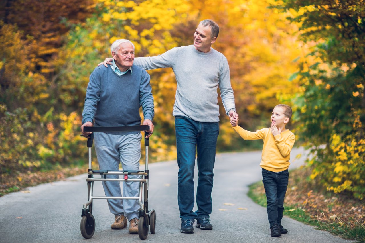 Agape Home senior assisted living allows for more freedom than you think. A grandfather, son and grandson walk down a road in autumn.