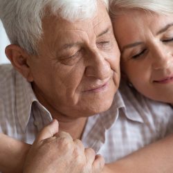 An older man and his daughter share a tender, yet somber, embrace. At DaySpring, our senior care services are supported by over 30 years of experience.